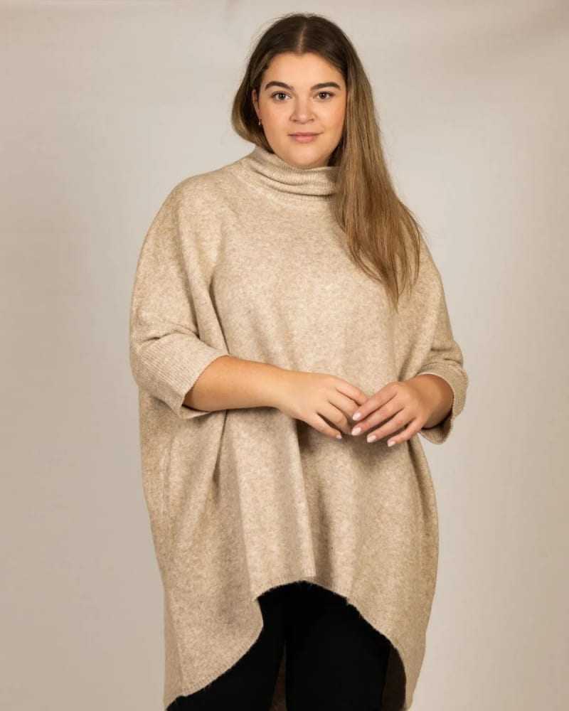 Side of a model wearing a size XL Charlotte Oversized Sweater High Neck in Taupe by ANNICK. | dia_product_style_image_id:317364
